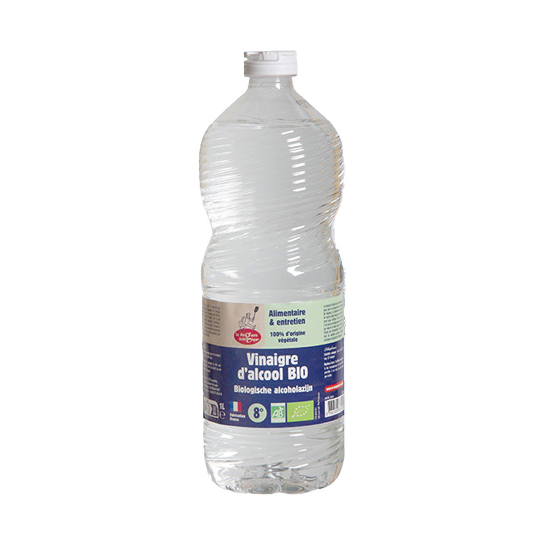 Clear bottle of organic alcohol vinegar with a label on a white background