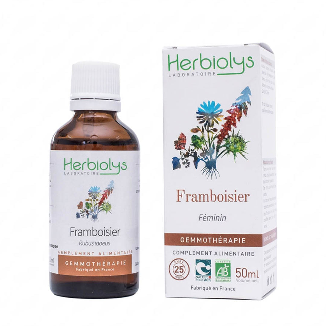 A bottle of Herbiolys Laboratoires Framboisier Féminin gemmothérapie supplement next to its white packaging box, featuring botanical illustrations and certification logos.