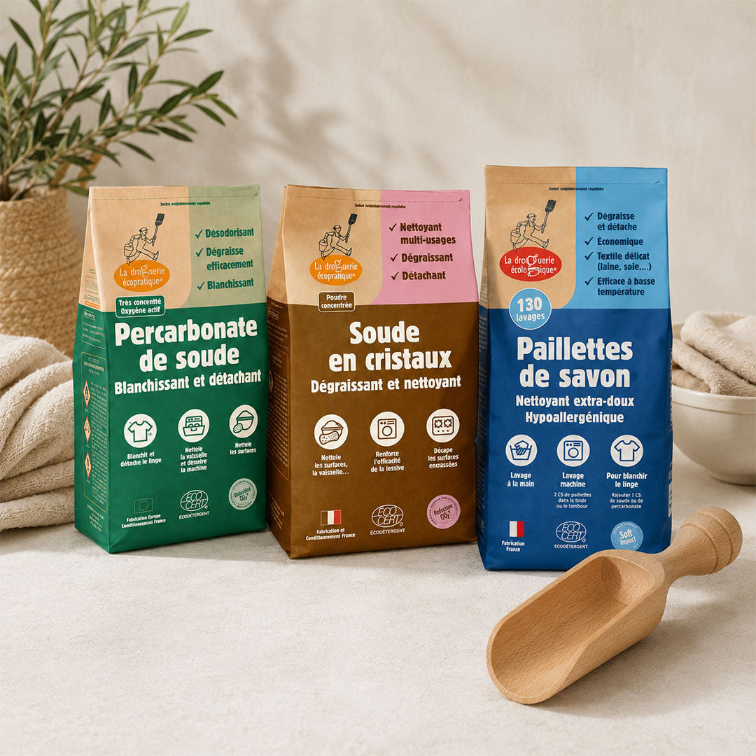 Natural Laundry Stain & Care Kit featuring sodium percarbonate, soda crystals, organic soap flakes and a beech wood scoop arranged together on a neutral surface for natural stain removal and eco-friendly laundry care.