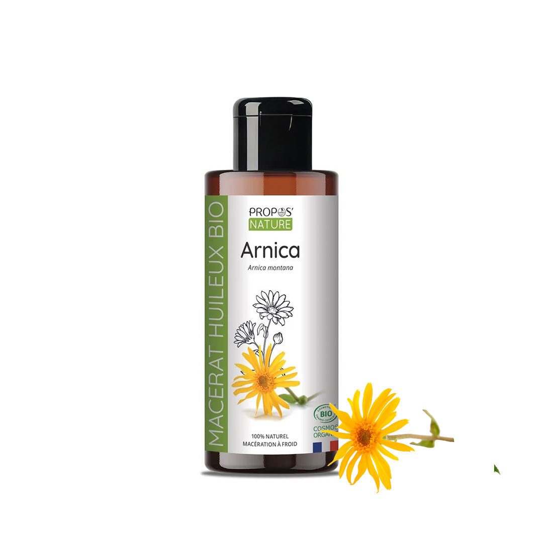 A bottle of Propos Nature Arnica Macerate Oil  with a black cap and white label, shown on a white background with a yellow Arnica flower graphic.