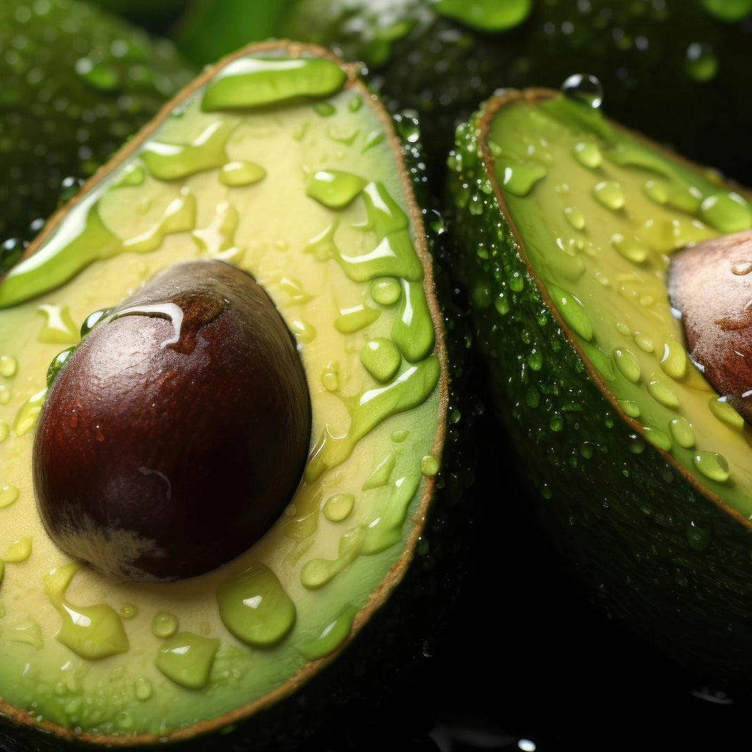 Avocados sliced in two with water drops on them