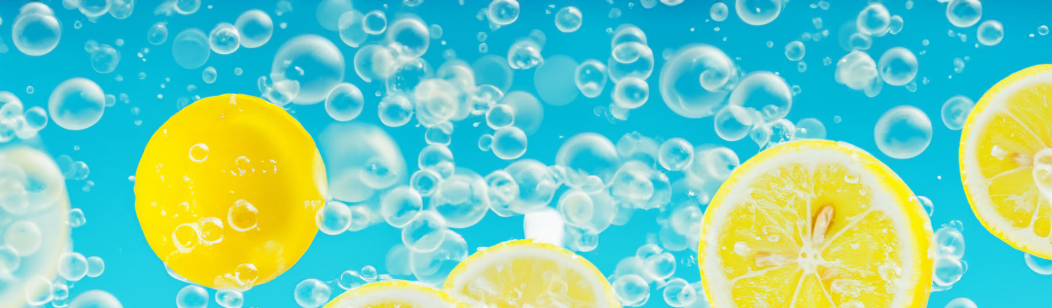 Lemons floating in water with soap bubbles