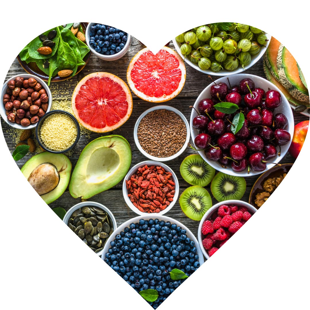 An image in the shape of a heart with berries, fruits, nuts