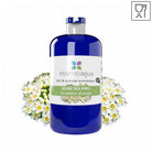 A bottle of essenciágua 100% aromatic fluid with a blue body and white label, flanked by white Meadowsweet flowers on a white background.