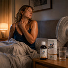 Woman in bed with a bottle and box of Herbaly's on a nightstand.