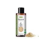 A bottle of Propos Nature Bio Sesame vegetable oil with a black cap and white label, shown on a white background with sesame seeds next to it.