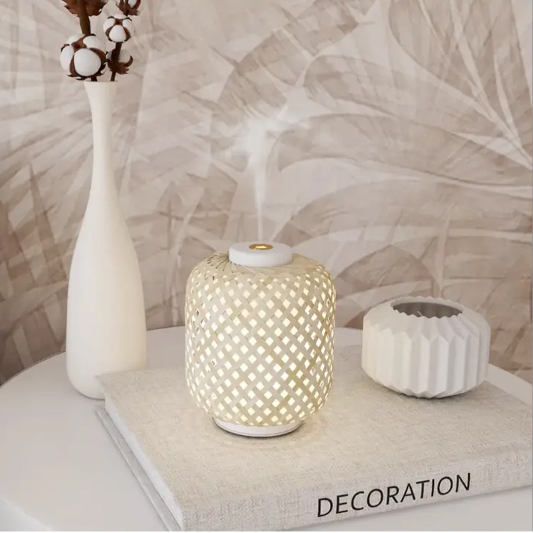 Vanelia aroma diffuser on a table with a vase and other decorations in daylight