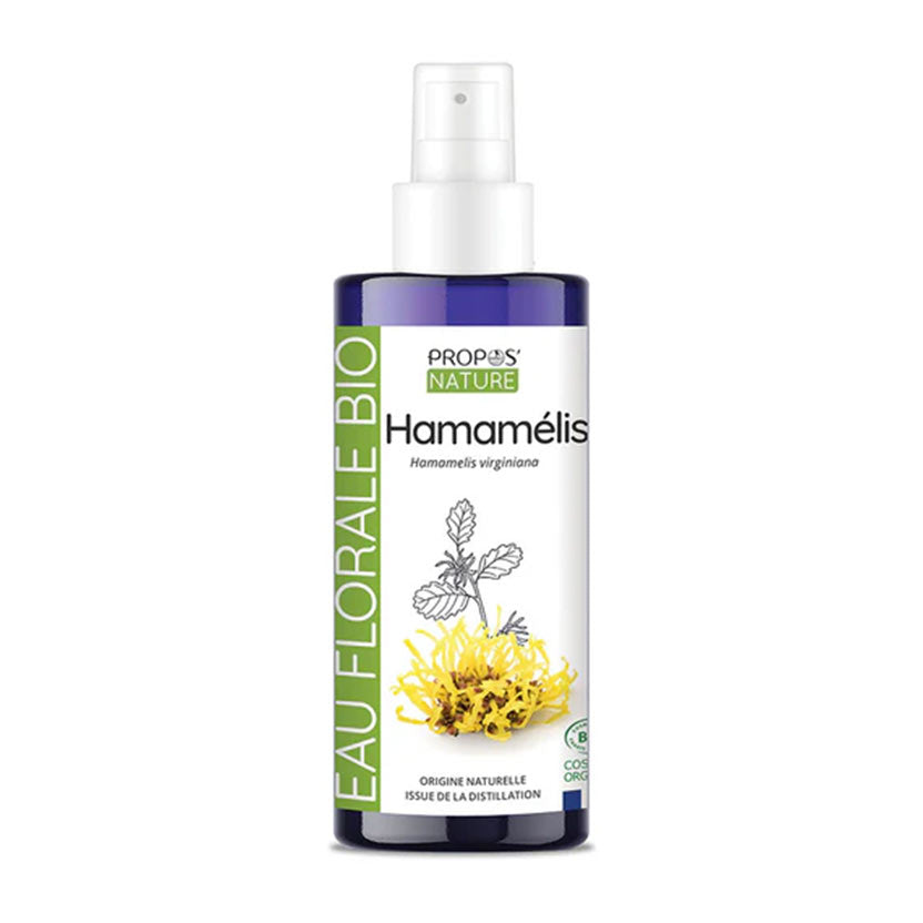 A bottle of Propos Nature Hamamélis Eau Florale Biohydrosol, featuring a  blue bottle with a green and white label, set against a plain white background.
