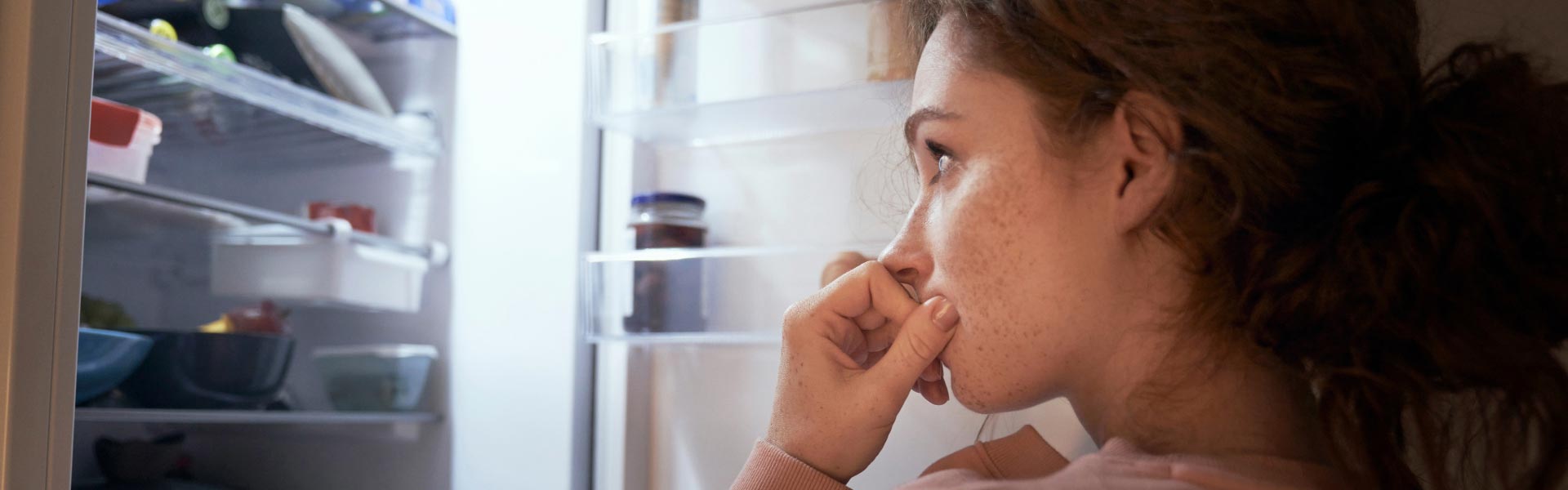 A woman looking into the fridge